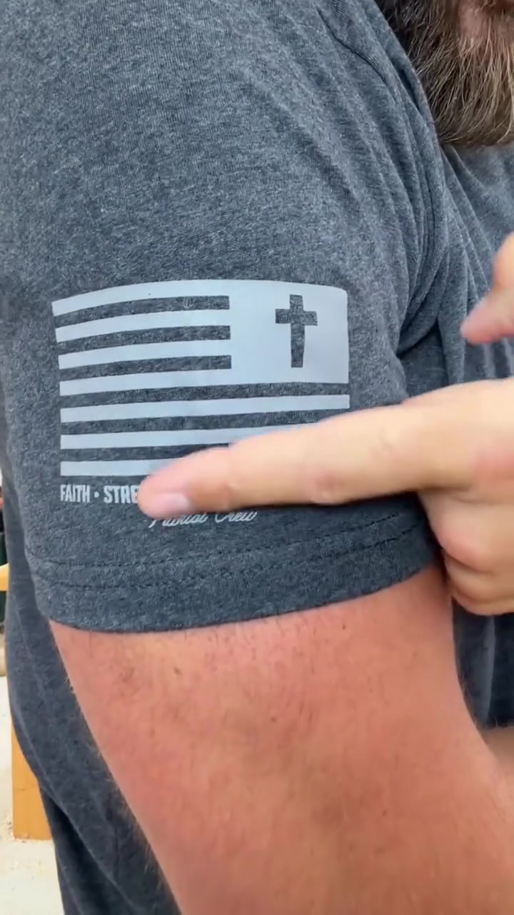 Close view of the small flag and cross mark on a Patriot Crew sleeve